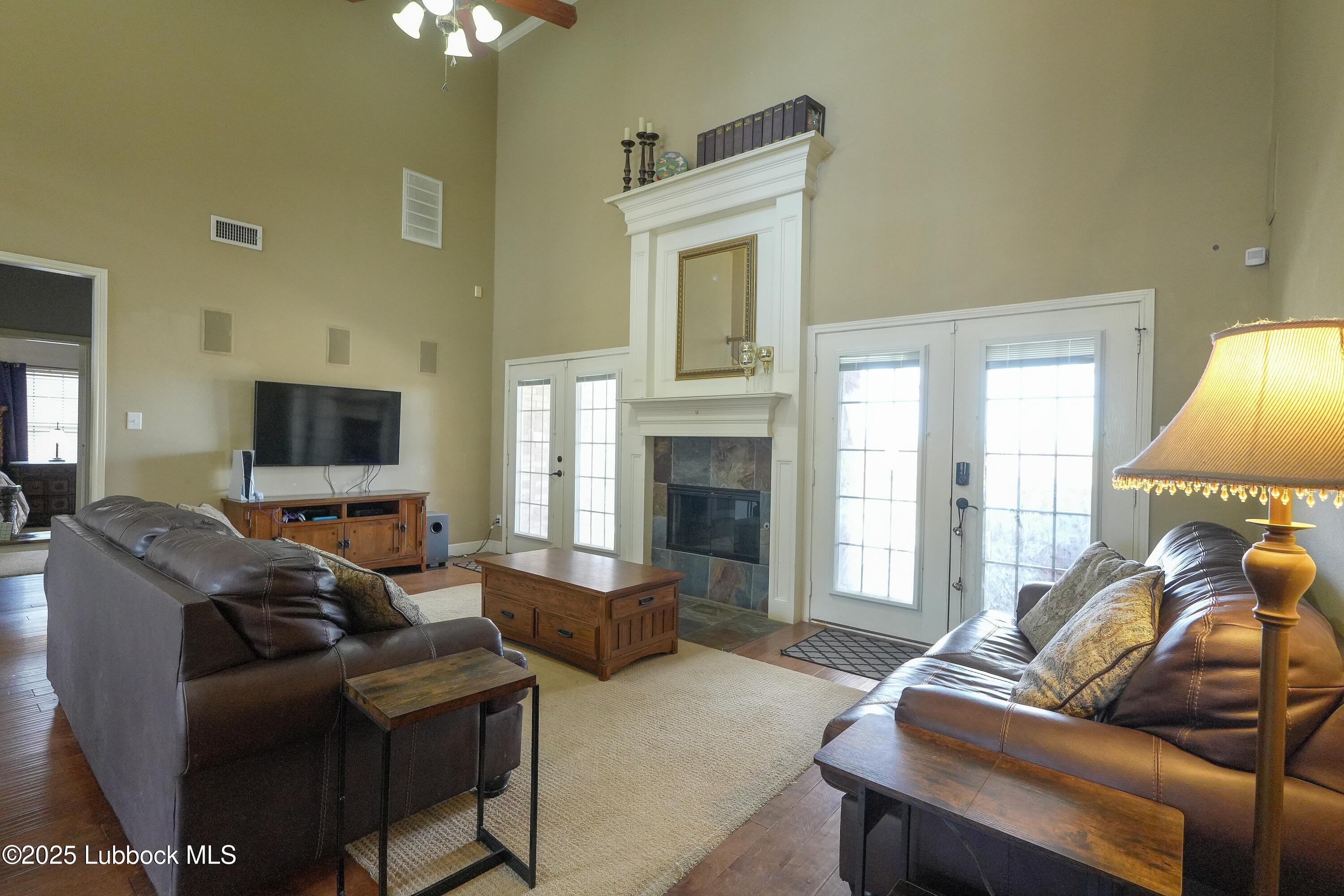 5904 110th Street Lubbock, TX 79424 - Photo 10 of 32 a living room with furniture a window and a flat screen tv