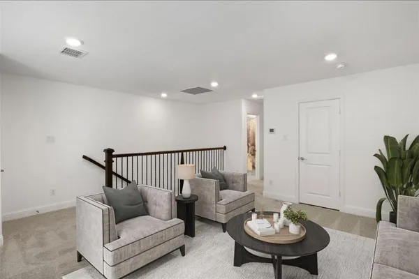 a living room with furniture and a potted plant