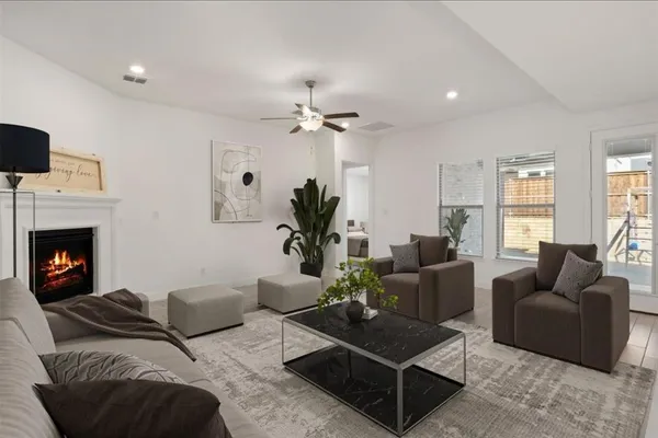 a living room with furniture a fireplace with wooden floor