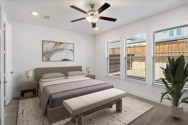 a bedroom with a bed and a large window