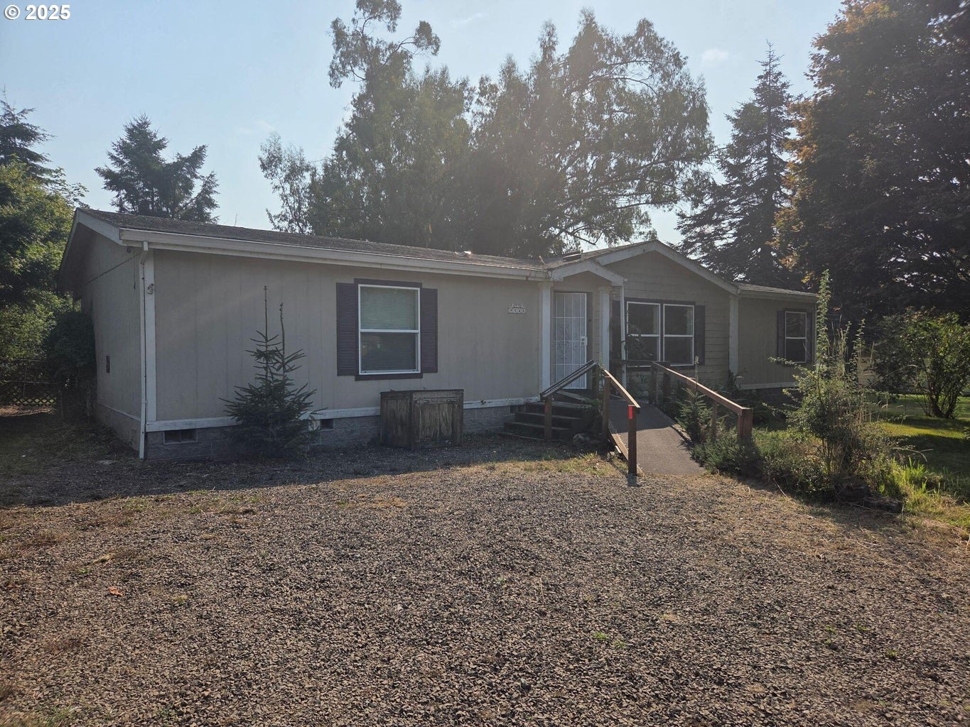 a backyard of a house with large trees and barbeque oven