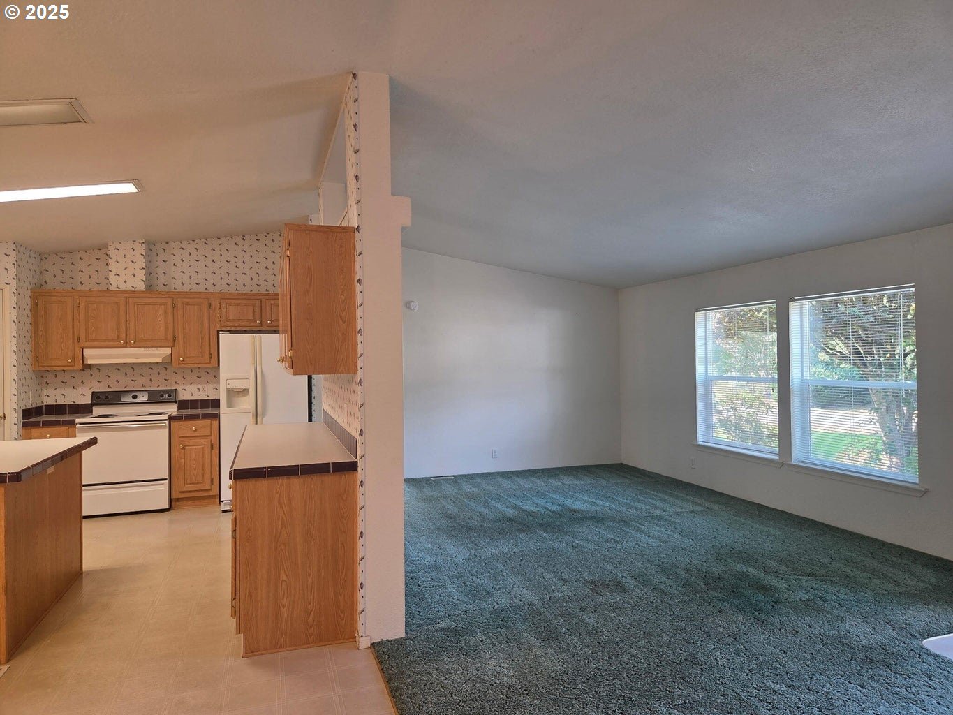 9225 Millcreek Road Tillamook, OR 97141 - Photo 4 of 19 a kitchen with stainless steel appliances granite countertop a stove a sink and a refrigerator
