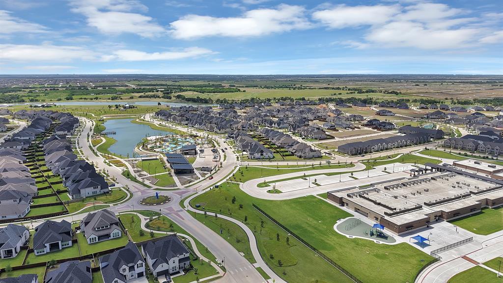 5012 Triadic Lane Prosper, TX 75078 - Photo 38 of 38 Expansive residential community featuring a central lake, extensive green spaces, a large school building, multiple recreational amenities, and curvilinear roadways