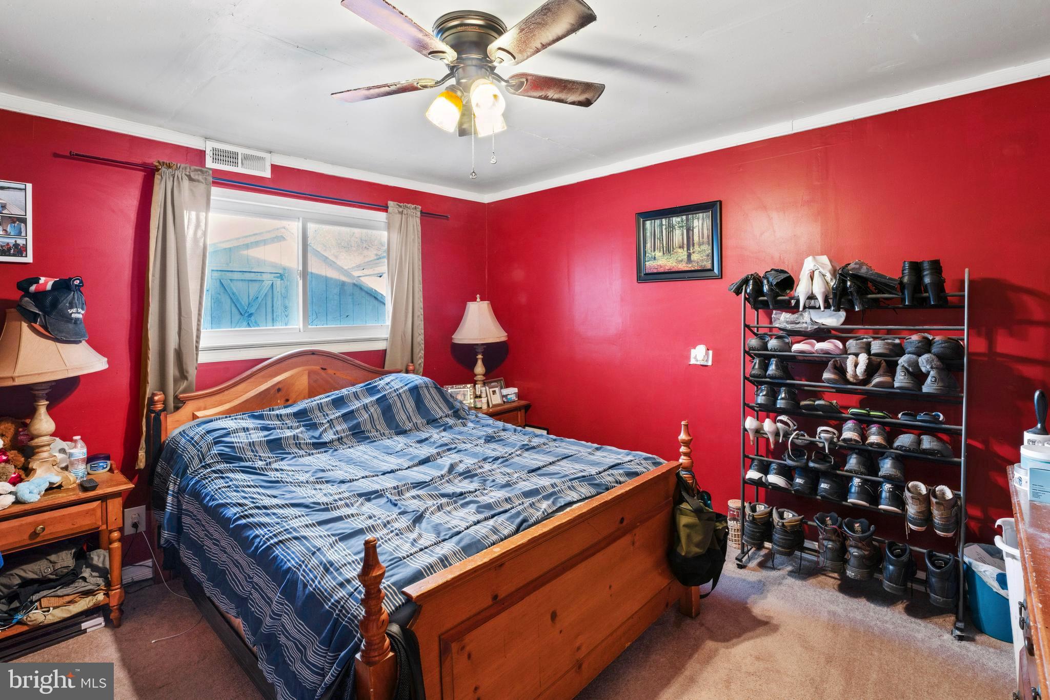 870 Downe Avenue Fortescue, NJ 08321 - Photo 12 of 26 a bedroom with a bed and a bookshelf with wooden floor