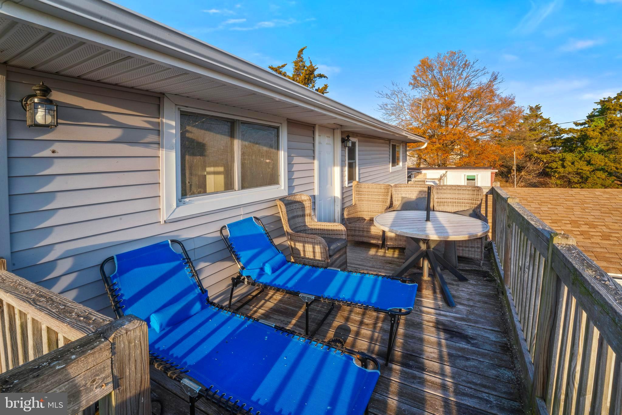 870 Downe Avenue Fortescue, NJ 08321 - Photo 23 of 26 a view of a roof deck with table and chairs with wooden floor and fence