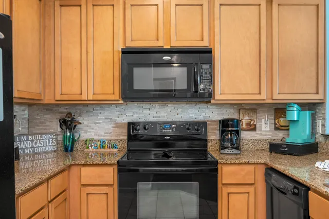 a bedroom with a large bed and a lamp on dresser