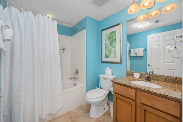 a bathroom with a sink vanity and toilet