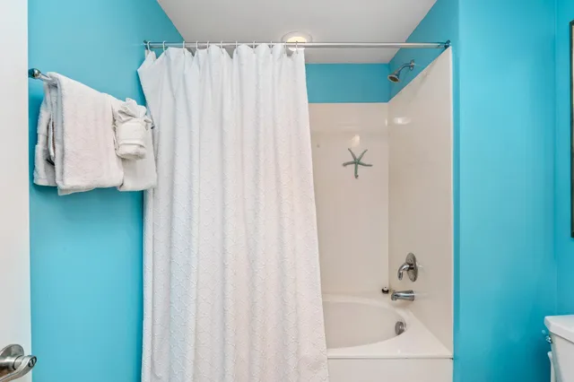 a bathroom with a shower and a sink