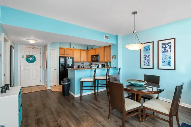 a kitchen with granite countertop white cabinets and black stainless steel appliances