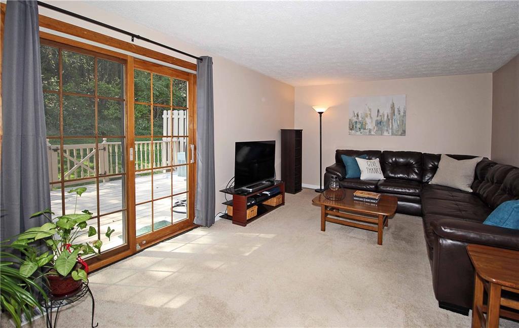 3143 Laurel Ridge Circle Bridgeville, PA 15017 - Photo 5 of 25 Spacious Living Room with Higher End Sliding Patio Door. View of Deck and Private Back Yard Area.