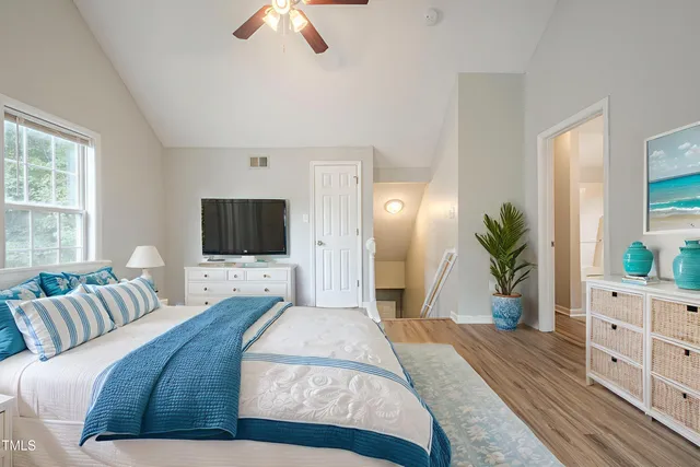 a kitchen with stainless steel appliances granite countertop a refrigerator a stove and a wooden floors