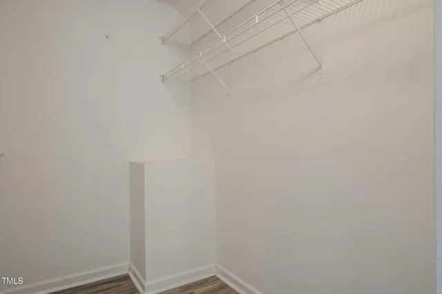 a bedroom with a large bed and a flat screen tv