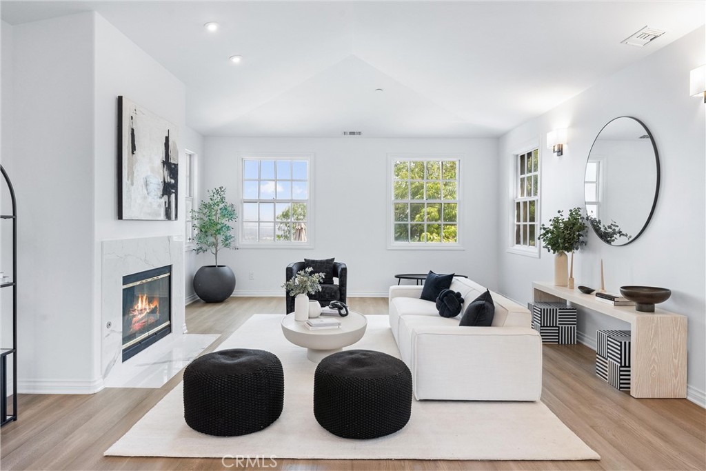 927 Avocado Crest Road La Habra Heights, CA 90631 - Photo 17 of 72 a living room with furniture a mirror and a wooden floor