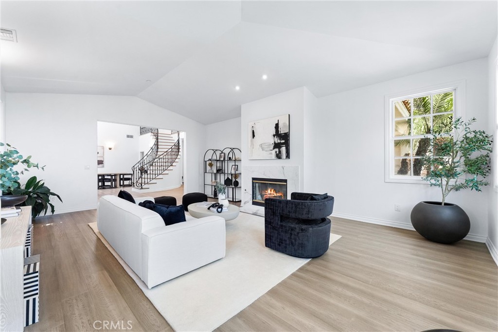 927 Avocado Crest Road La Habra Heights, CA 90631 - Photo 18 of 72 a living room with furniture a flat screen tv and a fireplace