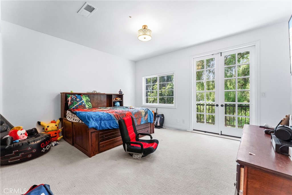 927 Avocado Crest Road La Habra Heights, CA 90631 - Photo 29 of 72 a bedroom with a bed and large windows