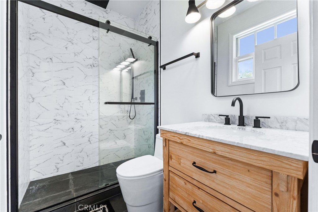 927 Avocado Crest Road La Habra Heights, CA 90631 - Photo 33 of 72 a bathroom with a granite countertop sink toilet and shower