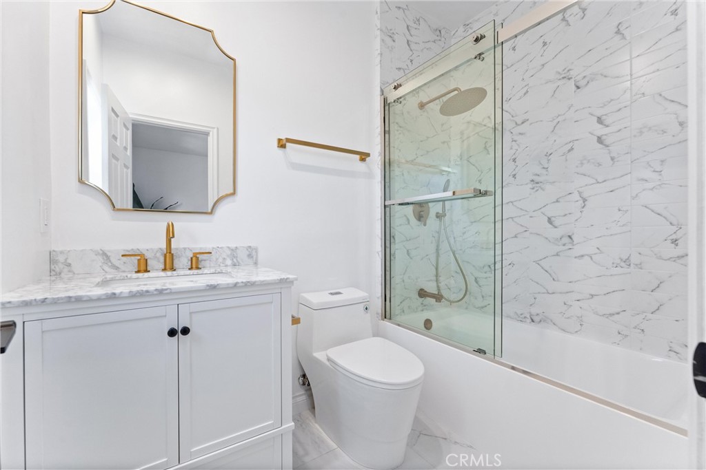 927 Avocado Crest Road La Habra Heights, CA 90631 - Photo 36 of 72 a bathroom with a granite countertop sink toilet a mirror a vanity and shower
