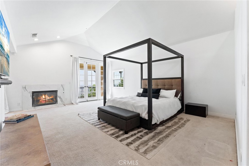 927 Avocado Crest Road La Habra Heights, CA 90631 - Photo 40 of 72 a spacious bedroom with a bed and a flat screen tv