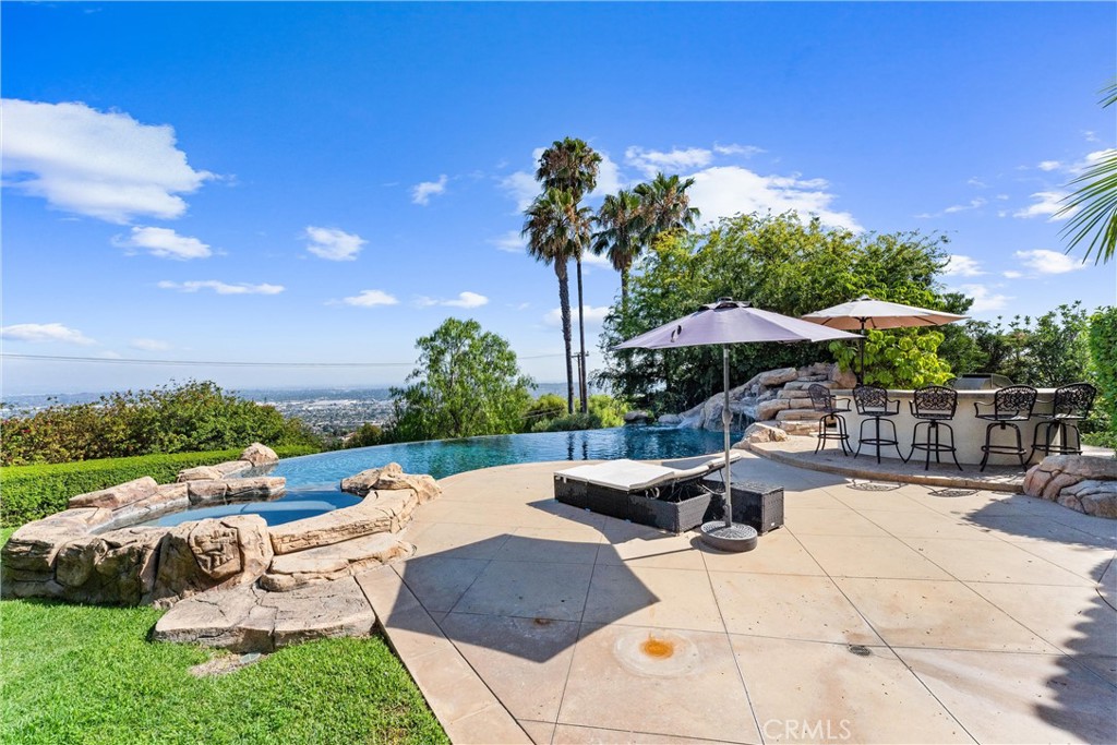 927 Avocado Crest Road La Habra Heights, CA 90631 - Photo 49 of 72 a view of a patio with a table and chairs under an umbrella