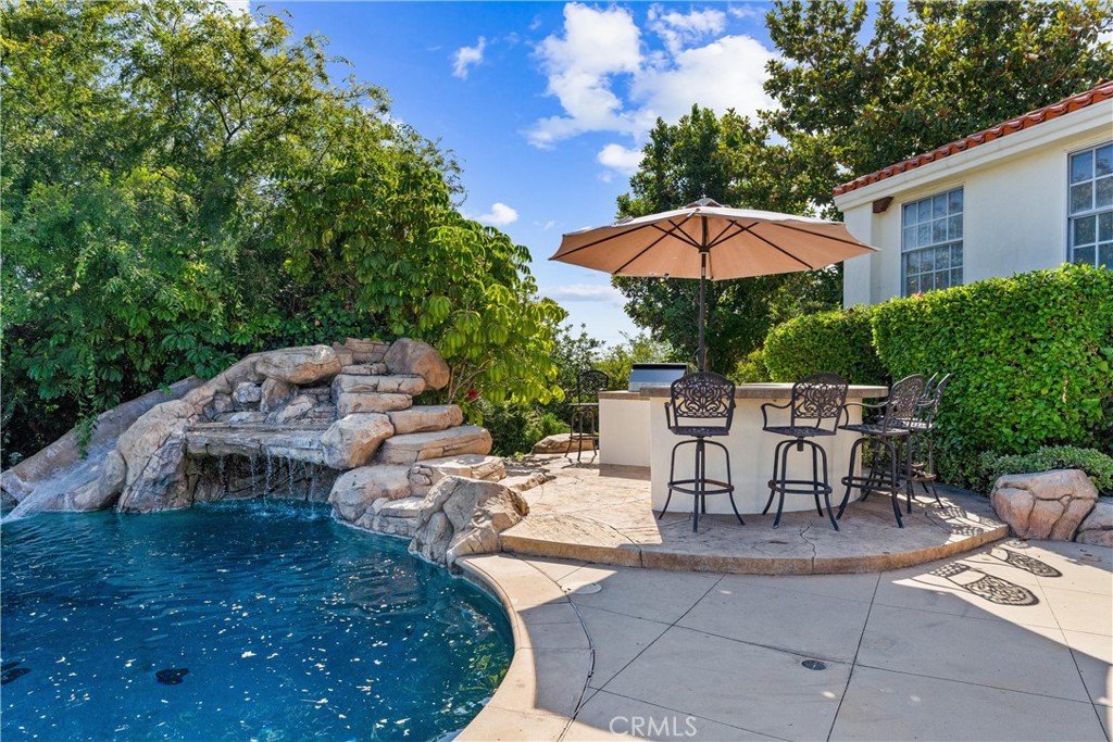 927 Avocado Crest Road La Habra Heights, CA 90631 - Photo 51 of 72 a view of a patio with a table and chairs under an umbrella
