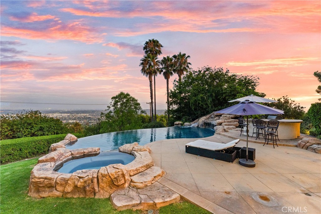 927 Avocado Crest Road La Habra Heights, CA 90631 - Photo 57 of 72 a view of a patio with couches and table and chairs under an umbrella