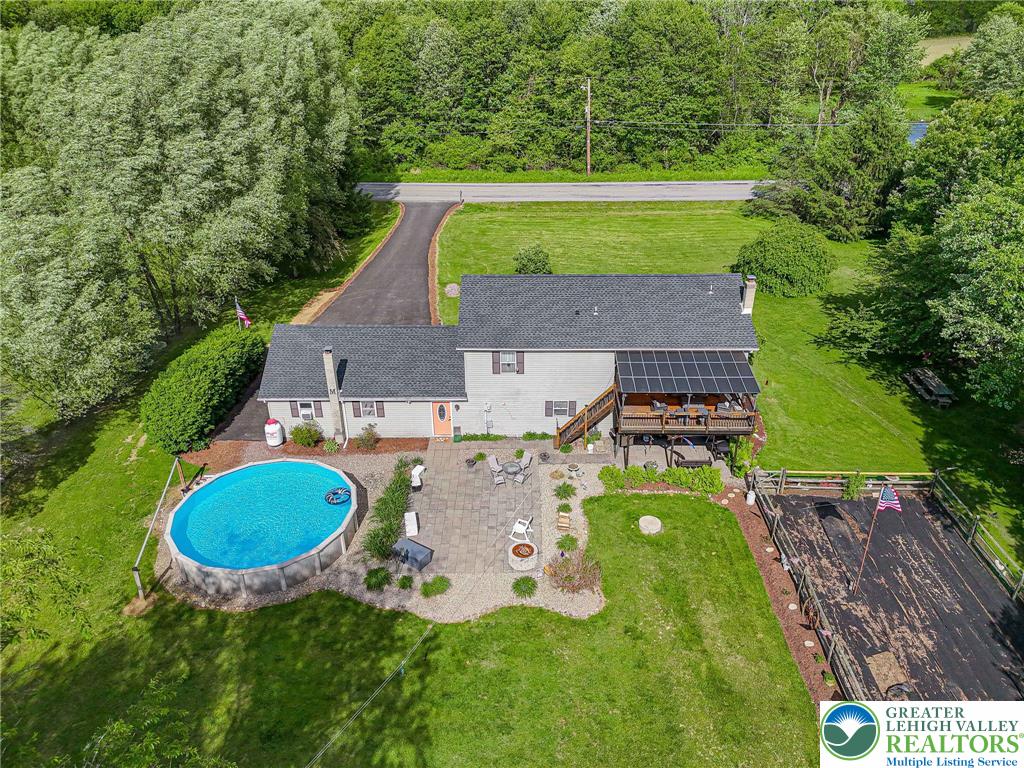341 Lower Greenhill Road Kunkletown, PA 18058 - Photo 56 of 69 An inviting backyard oasis offers a pool, spacious patio, and a covered upper deck.