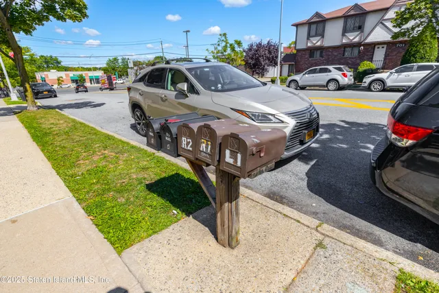 a car parked in front of a house with a view of a city street