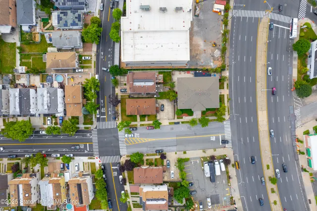 a front view of a house with swimming pool and garden