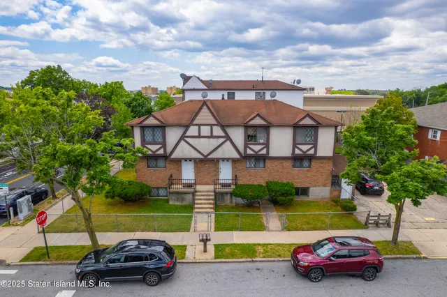 an aerial view of a house with a yard basket ball court and outdoor seating