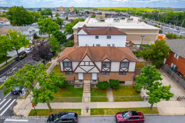 an aerial view of a house with a yard and garden