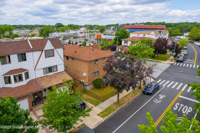 an aerial view of a house with a garden and mountain view in back