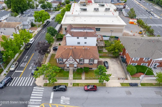 an aerial view of a house with a garden and mountain view in back