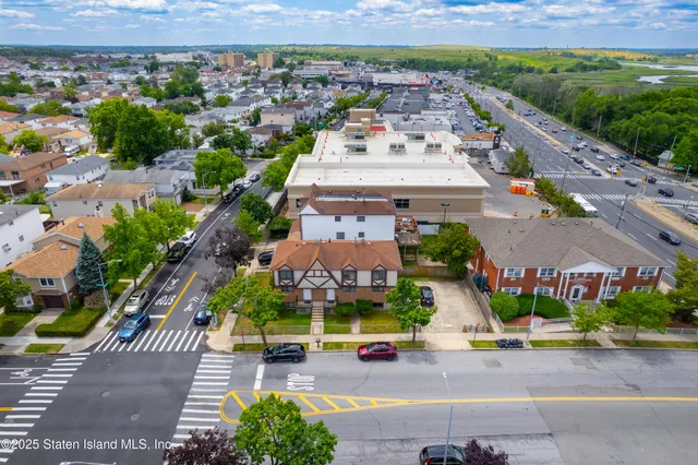 an aerial view of residential houses with outdoor space