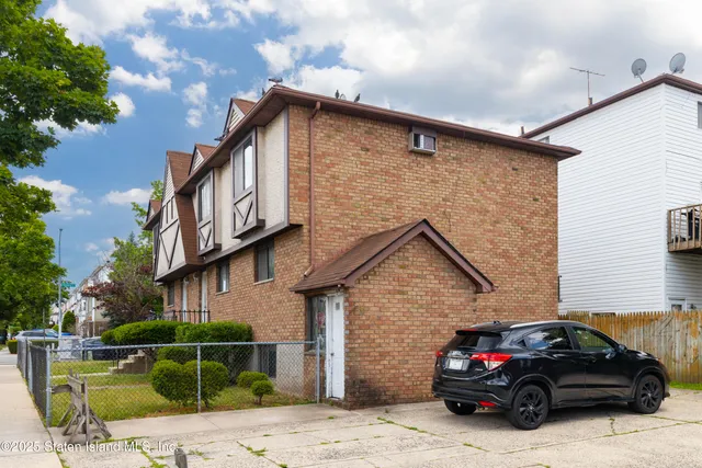 a view of a house with pool and sitting area