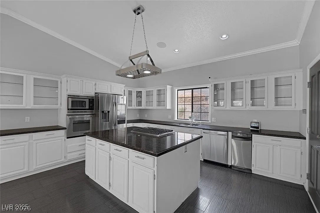 9 Quail Run Road Henderson, NV 89014 - Photo 21 of 57 Culinary delights await in this bright kitchen, featuring stainless steel appliances and ample counter space.