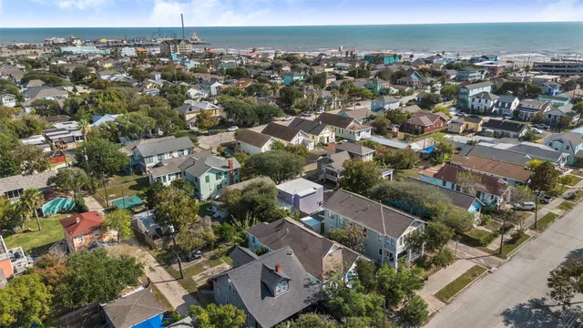 an aerial view of residential houses with outdoor space