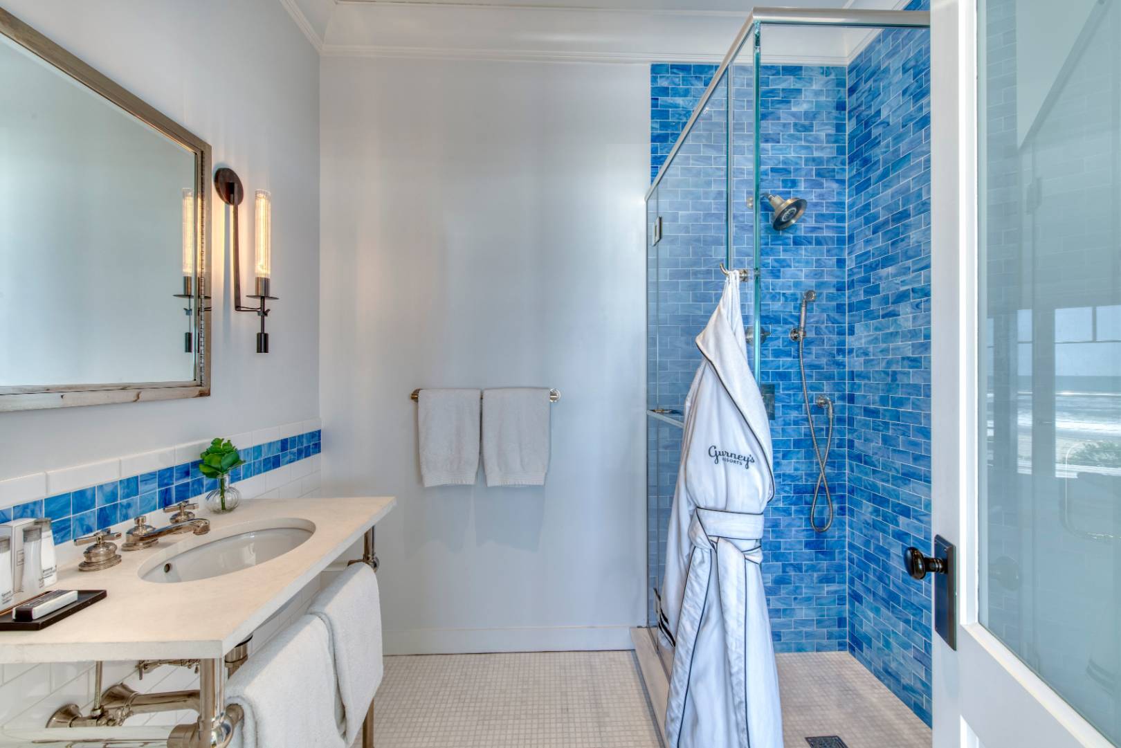 272 Old Montauk Highway, Unit 9 Montauk, NY 11954 - Photo 11 of 26 a bathroom with a sink and a mirror