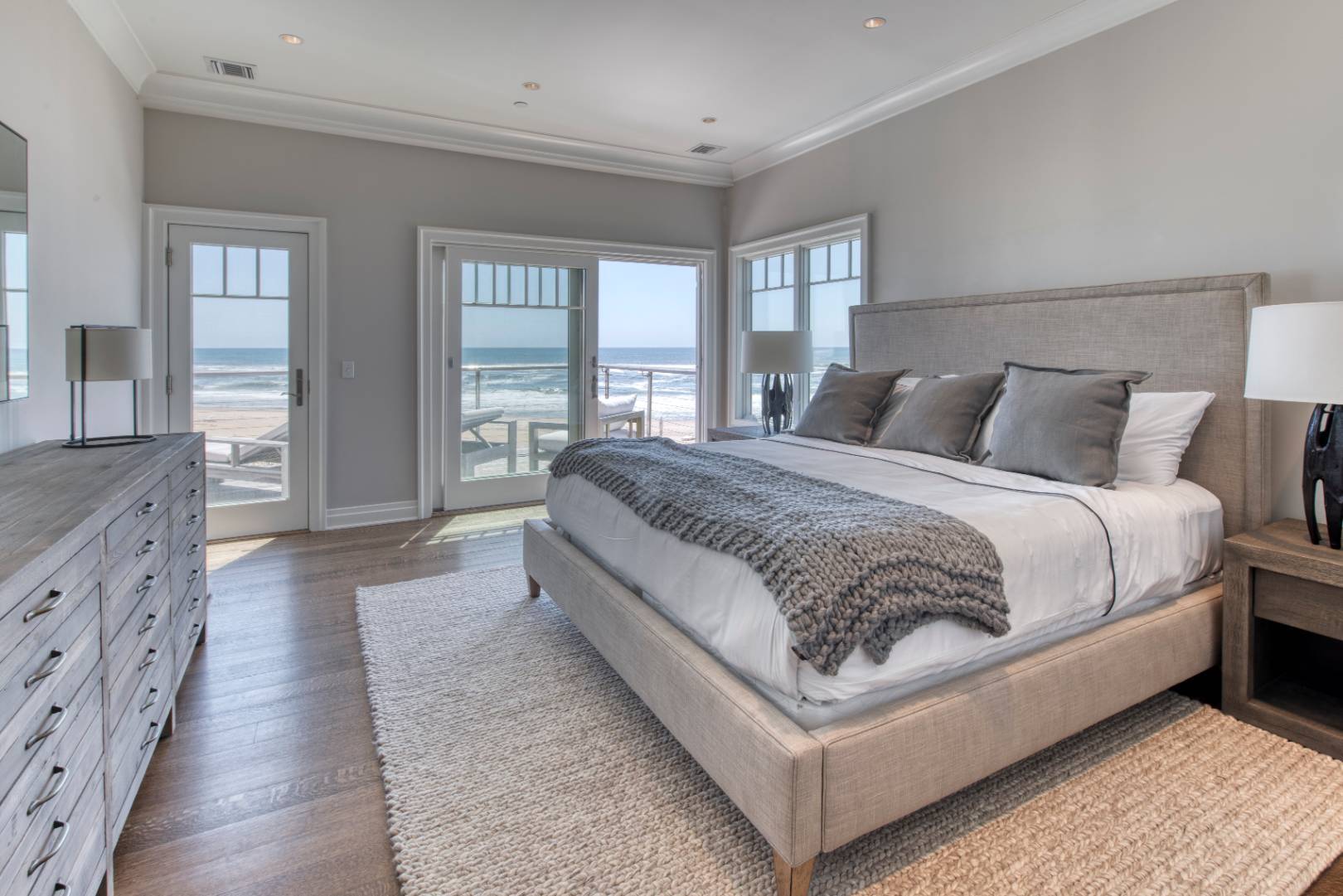 272 Old Montauk Highway, Unit 9 Montauk, NY 11954 - Photo 7 of 26 a spacious bedroom with a bed and glass windows