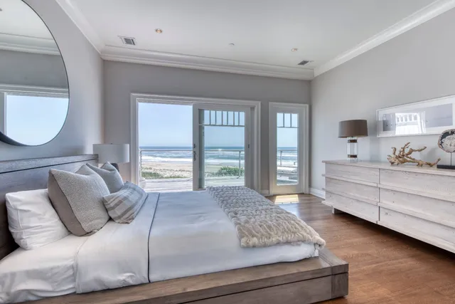 a bedroom with a large bed and a dresser