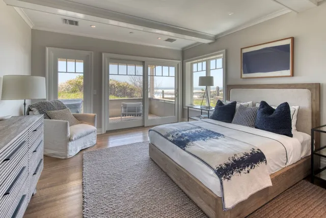 a bedroom with bed and large window