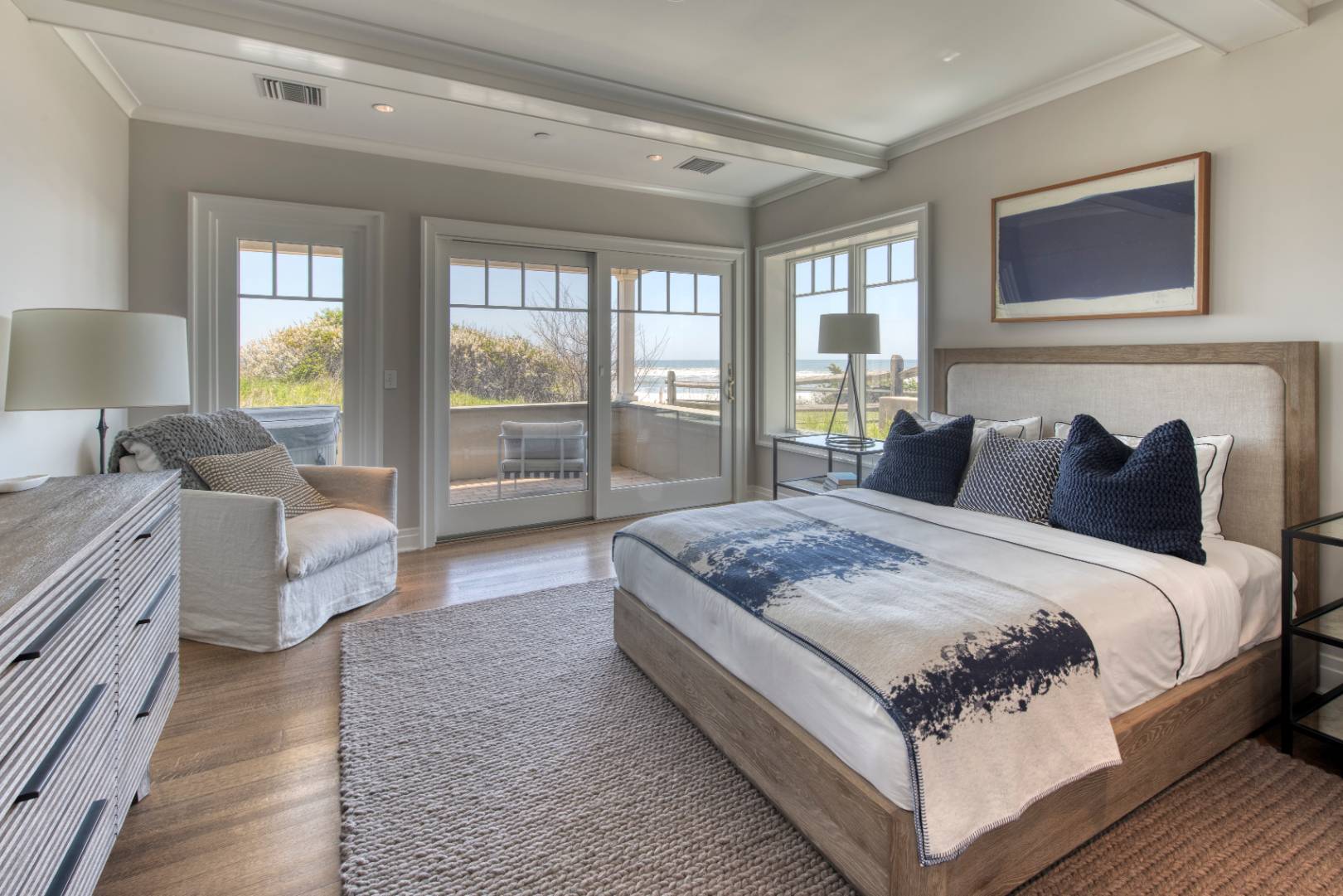 272 Old Montauk Highway, Unit 9 Montauk, NY 11954 - Photo 10 of 26 a bedroom with bed and large window