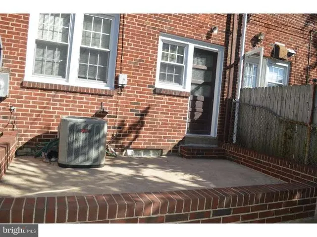 a view of a brick building next to a yard
