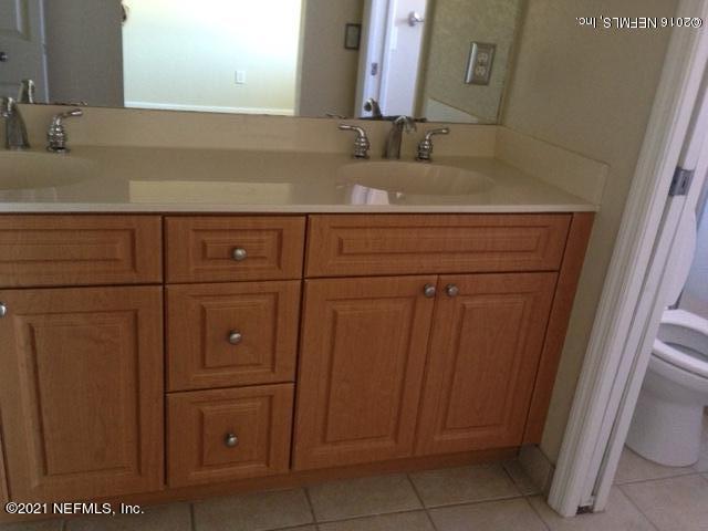 9745 Touchton Road, Unit 1823 Jacksonville, FL 32246 - Photo 11 of 18 a bathroom with a sink and vanity