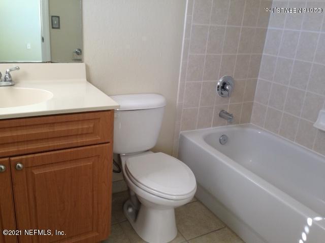 9745 Touchton Road, Unit 1823 Jacksonville, FL 32246 - Photo 16 of 18 a white toilet sitting next to a bath tub