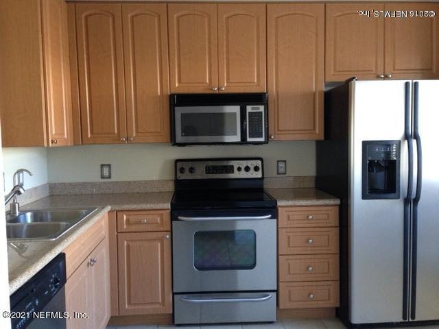 9745 Touchton Road, Unit 1823 Jacksonville, FL 32246 - Photo 3 of 18 a kitchen with stainless steel appliances granite countertop a refrigerator stove and sink