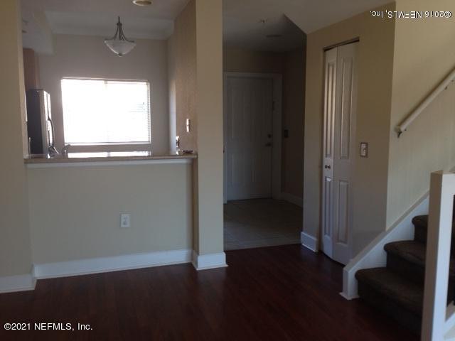 9745 Touchton Road, Unit 1823 Jacksonville, FL 32246 - Photo 7 of 18 a view of an empty room with wooden floor and a window
