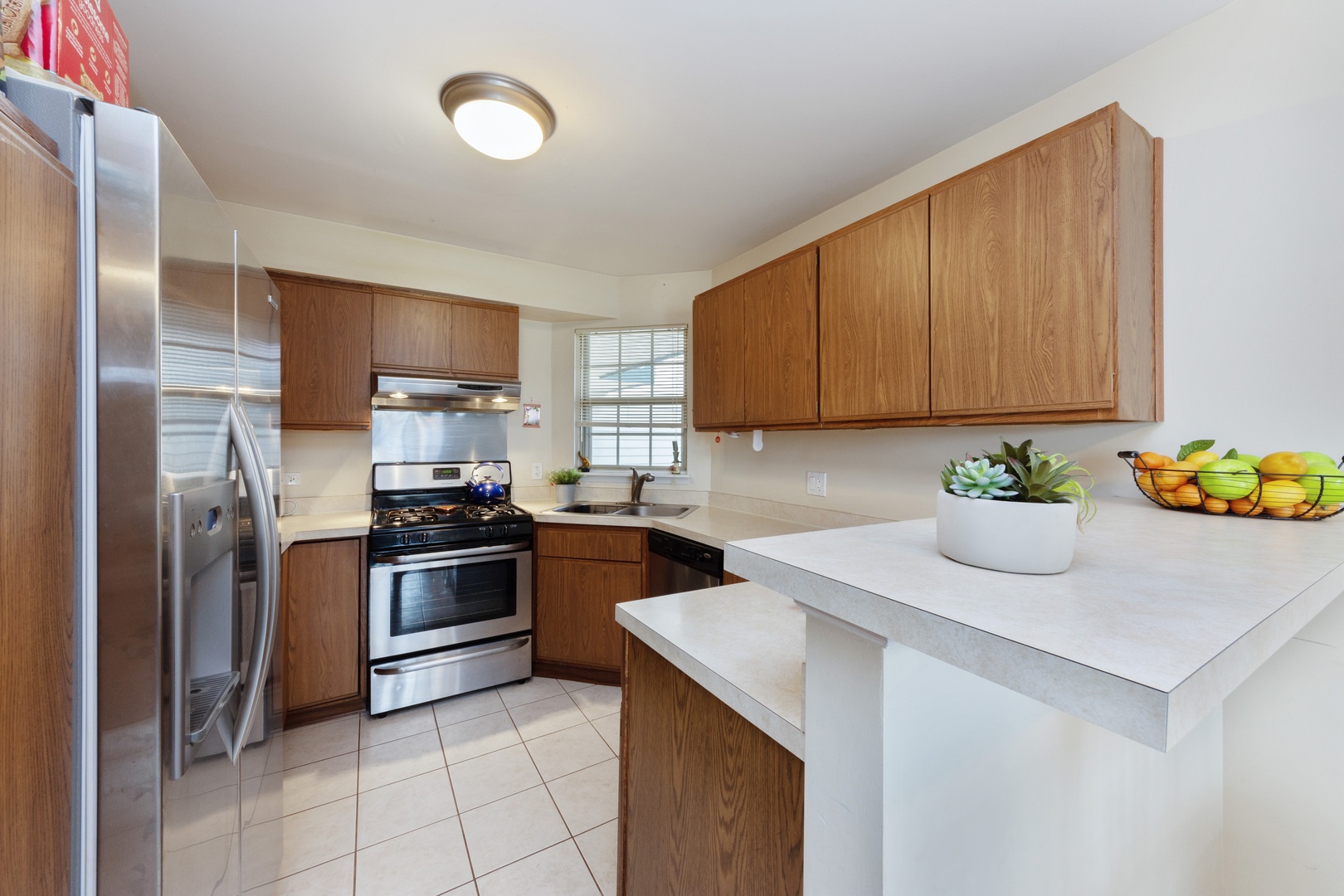 994 Ridgefield Lane, Unit 51 Wheeling, IL 60090 - Photo 2 of 10 a kitchen with stainless steel appliances granite countertop a refrigerator sink and stove