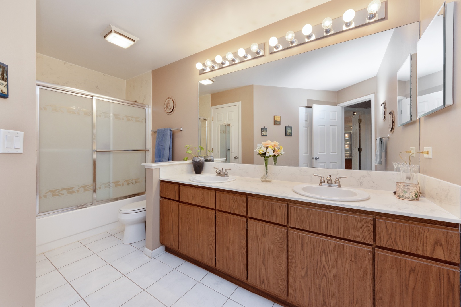 994 Ridgefield Lane, Unit 51 Wheeling, IL 60090 - Photo 6 of 10 a bathroom with a double vanity sink a toilet a mirror and shower