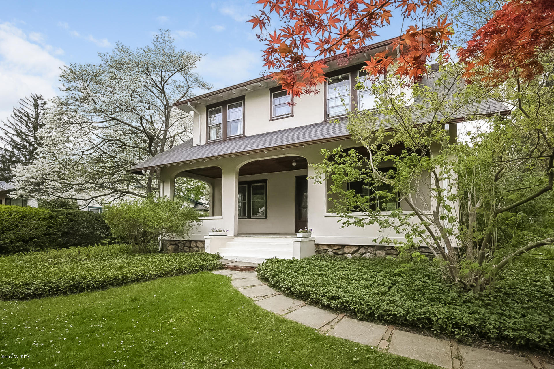 83 Indian Field Road Greenwich, CT 06830 - Photo 1 of 18 a front view of a house with a yard and trees
