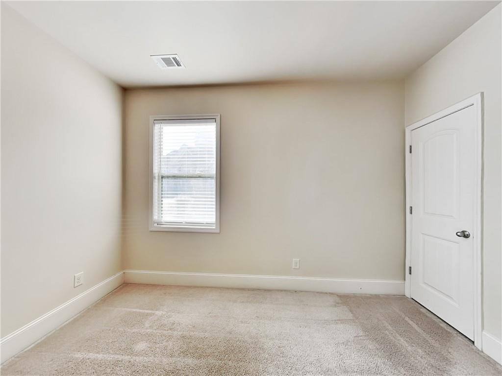 7770 Harbison Hollow Lane Suwanee, GA 30024 - Photo 12 of 25 an empty room with a window